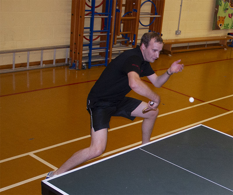 A Nick trying to play table tennis